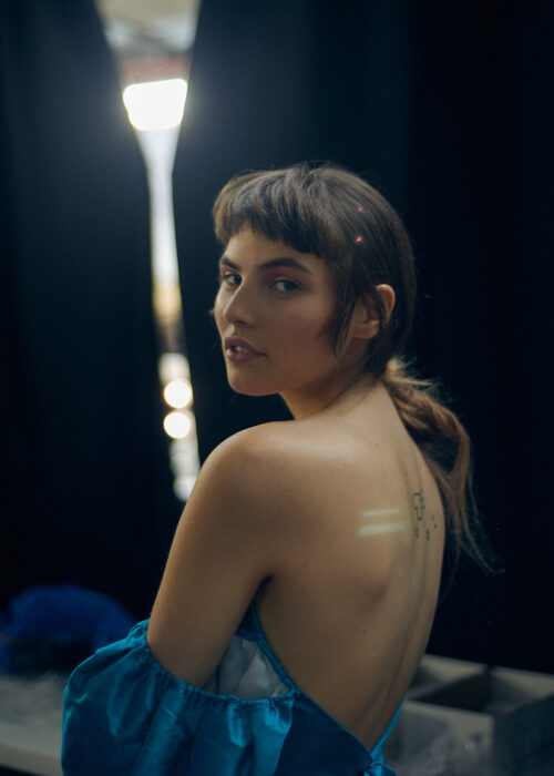 Backstage fashion portrait of woman in blue dress backstage