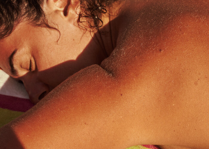 Close-up lifestyle image of sun-kissed shoulders at the beach.