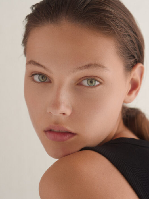 Close-up beauty portrait of woman with bare shoulder.